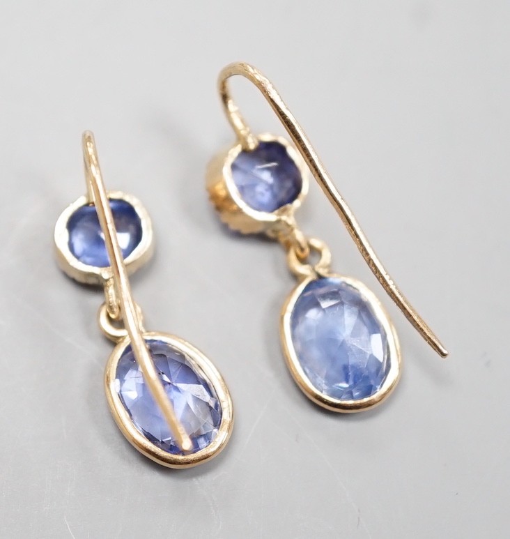A pair of 14k yellow metal and two stone sapphire set drop earrings, 23mm, gross weight 2.4 grams.